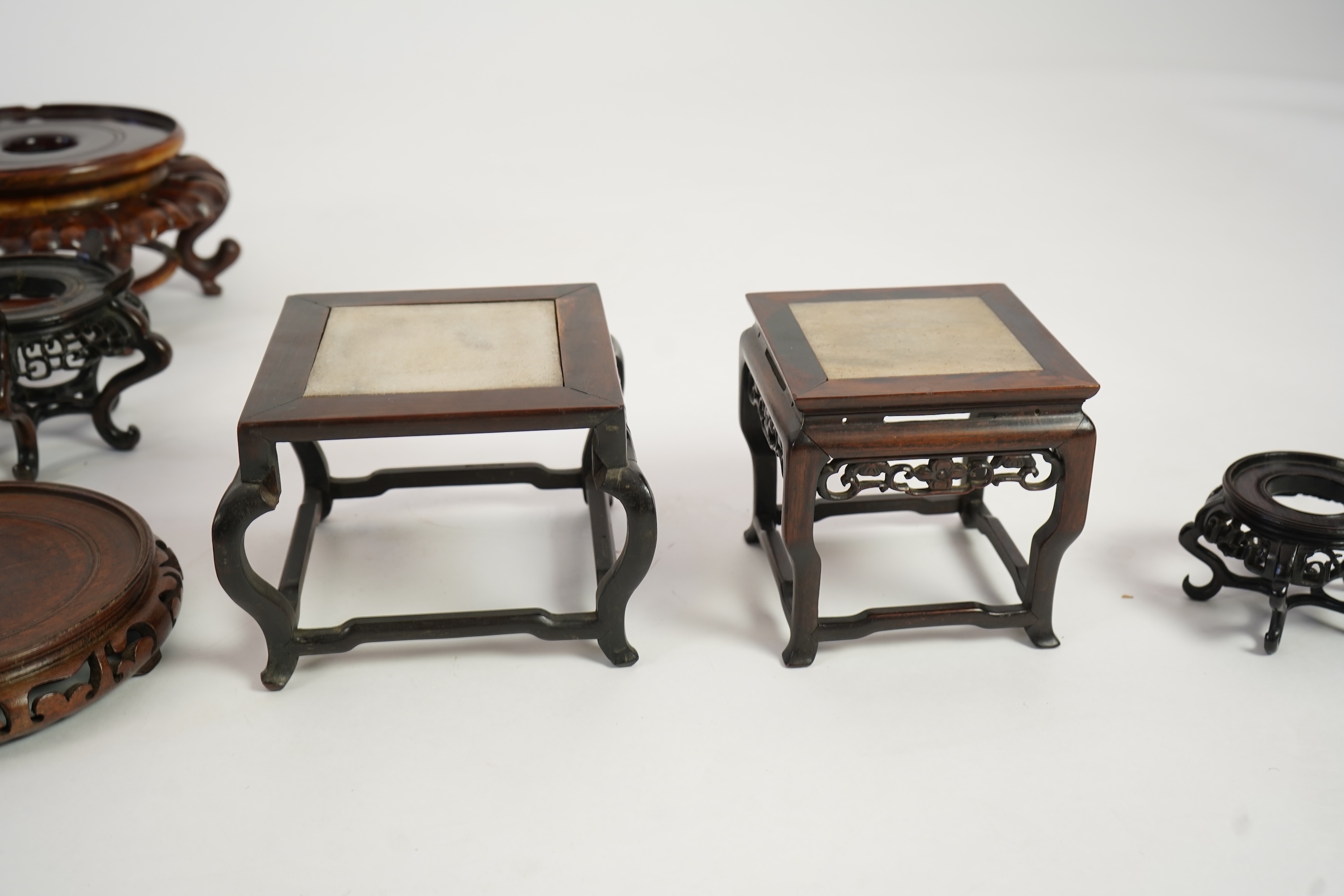 A group of sixteen Chinese hardwood stands together with a Japanese stand, 19th/20th century